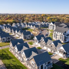 Drone shot of cottage home and apartment community Drone shot of cottage home and apartment community