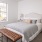 Furnished bedroom with single bed next to large window inside a townhome at Reserve at Sono