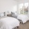 Secondary bedroom with two beds next to large window inside a townhome at Reserve at Sono
