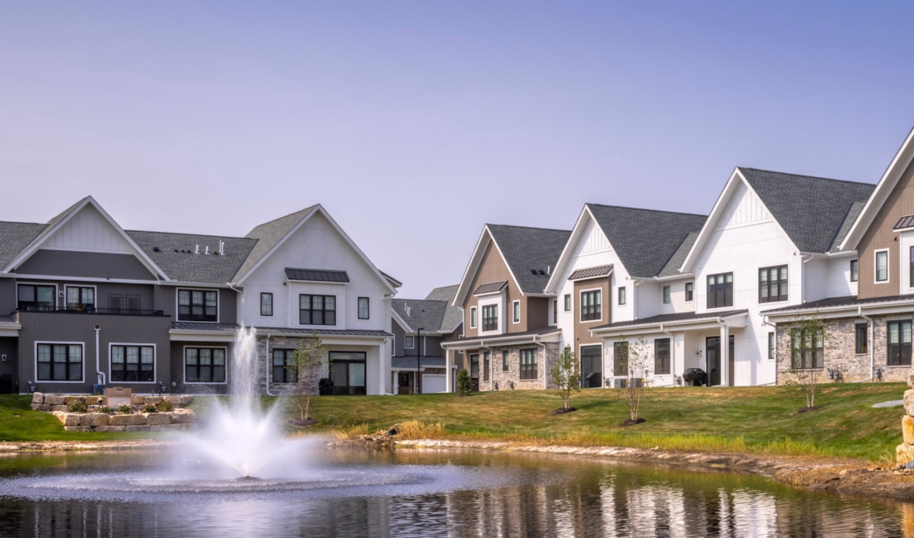 Reserve at Sono community pond with fountain surrounded by beautiful cottage homes Reserve at Sono community pond with fountain surrounded by beautiful cottage homes
