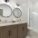 modern bathroom with round mirrors and glass shower